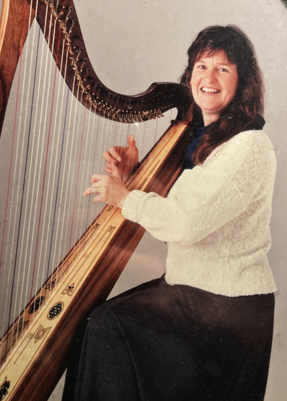 Georganne with harp in studio